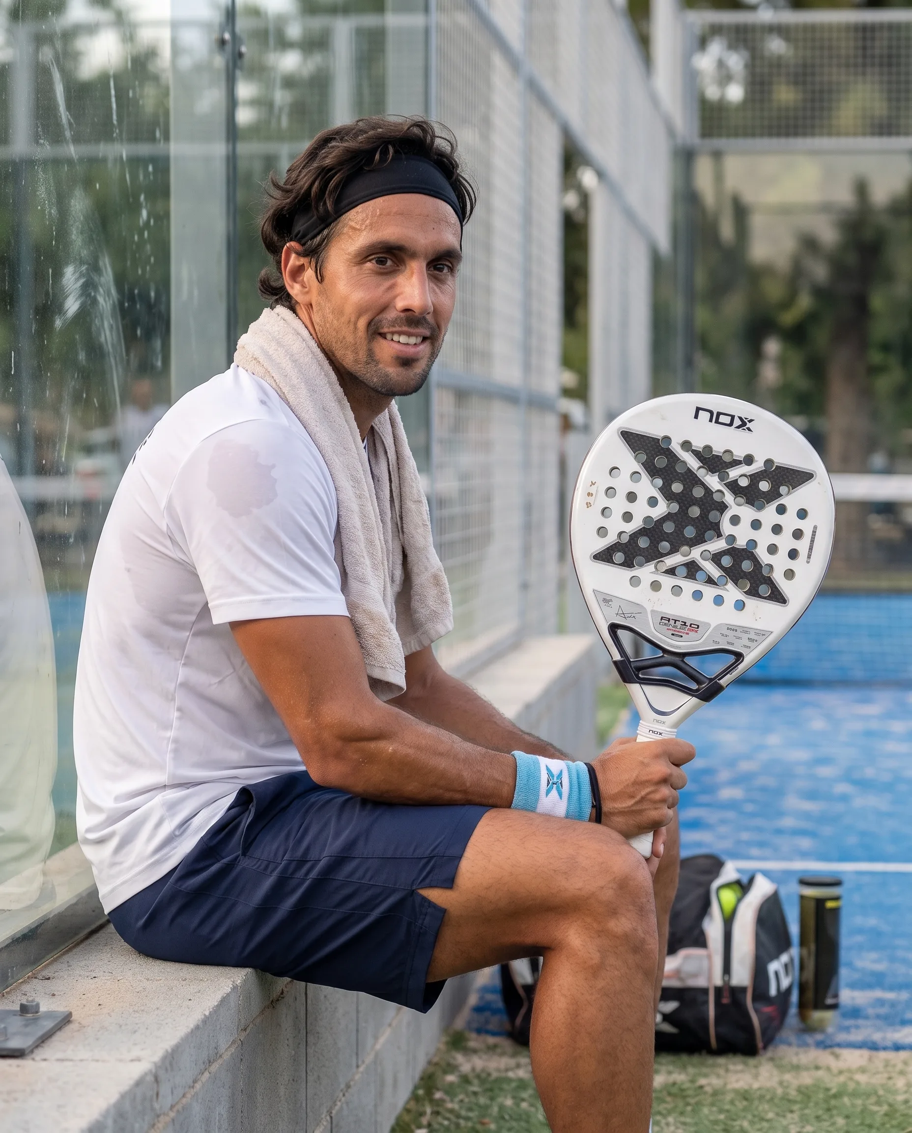 Player resting courtside after a match with the Nox AT10 Genius 12K Lite